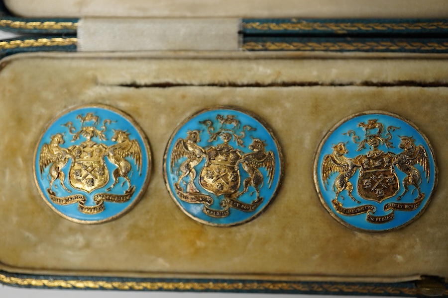 A George V set of 6 blue enamelled silver gilt buttons with armorial and motto 'cumnia subjescisti subpedieue oves et loves', Elkington and Co, Crown Jewellers, Chester 1904, in original case inscribed 'With The Complime